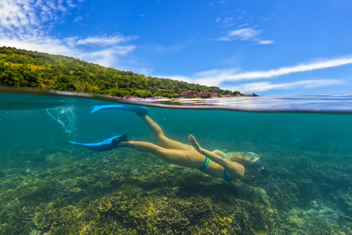 Woman snorkeling among coral